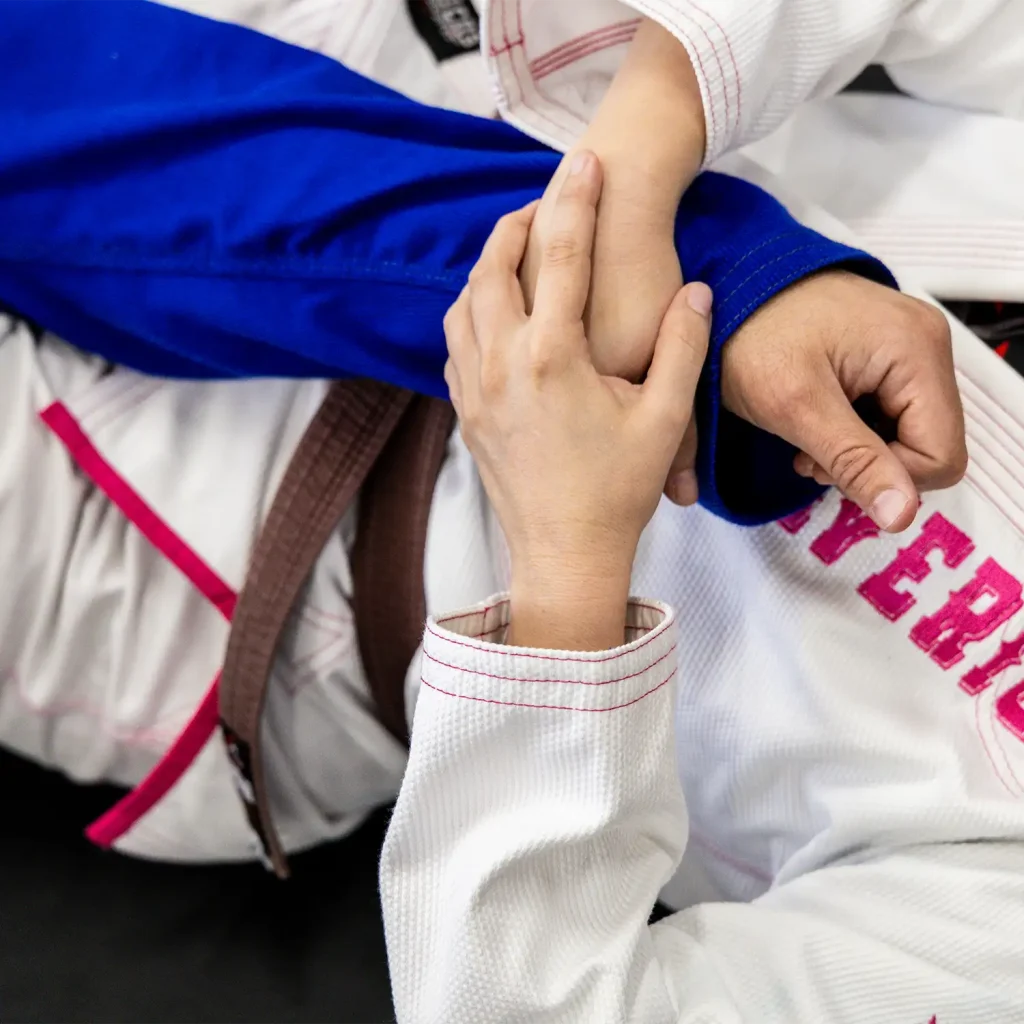 Child practicing Brazilian Jiu-Jitsu grip control during kids BJJ training, learning discipline and technique