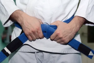 Brazilian Jiu-Jitsu blue belt tied on a gi, representing the meaning and foundation of a blue belt at Mavericks BJJ